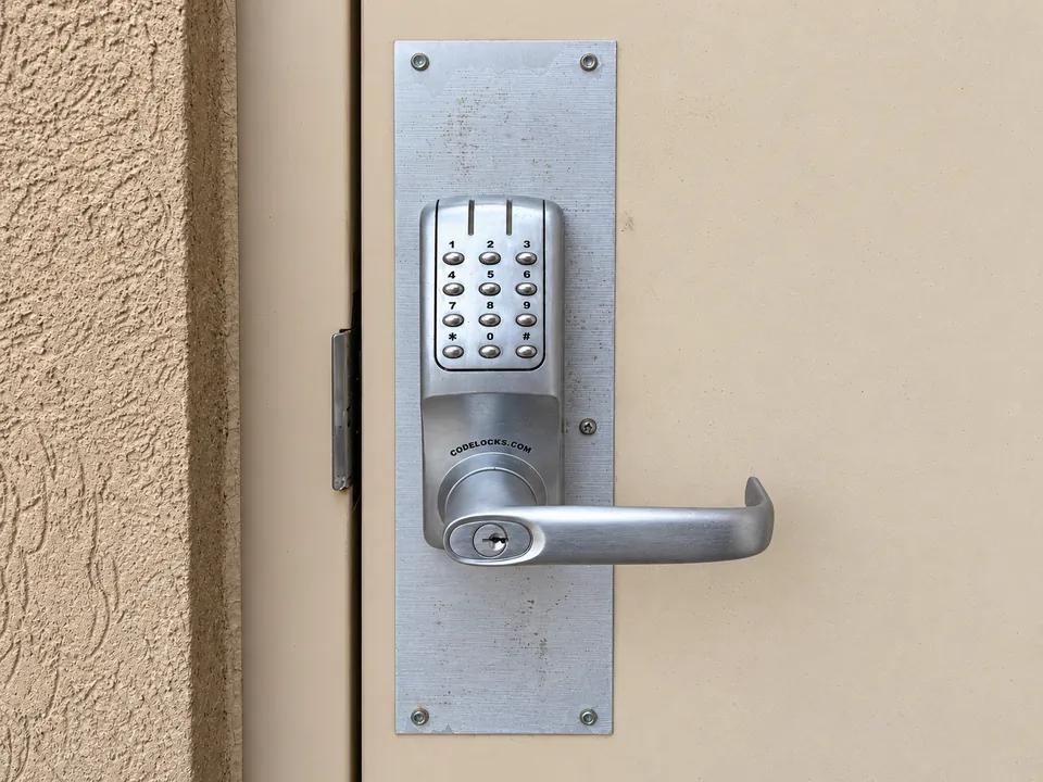 Push-button keypad lock and lever handle on a commercial door